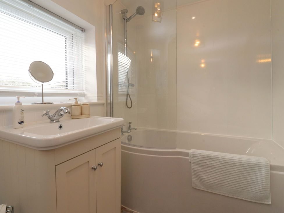 A bathroom featuring a bath and sink at Brook House in Broughton, Lancashire