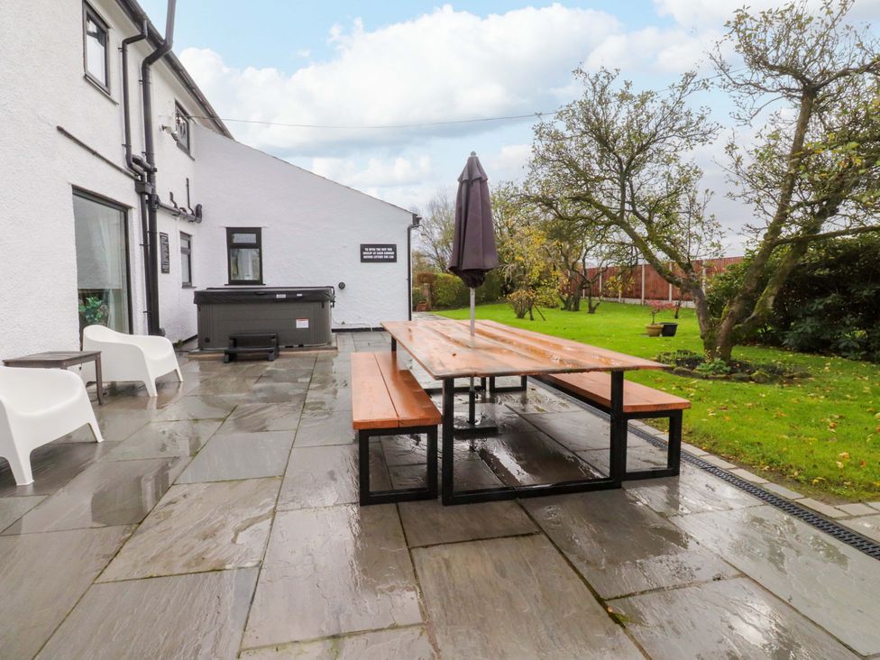 An outdoor seating area with a table and umbrella at Brook House, Broughton, Lancashire