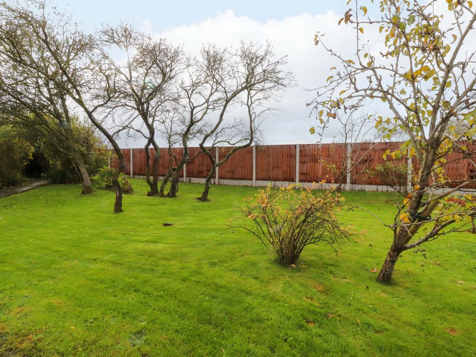 A garden with trees and grass at Brook House in Broughton, Lancashire