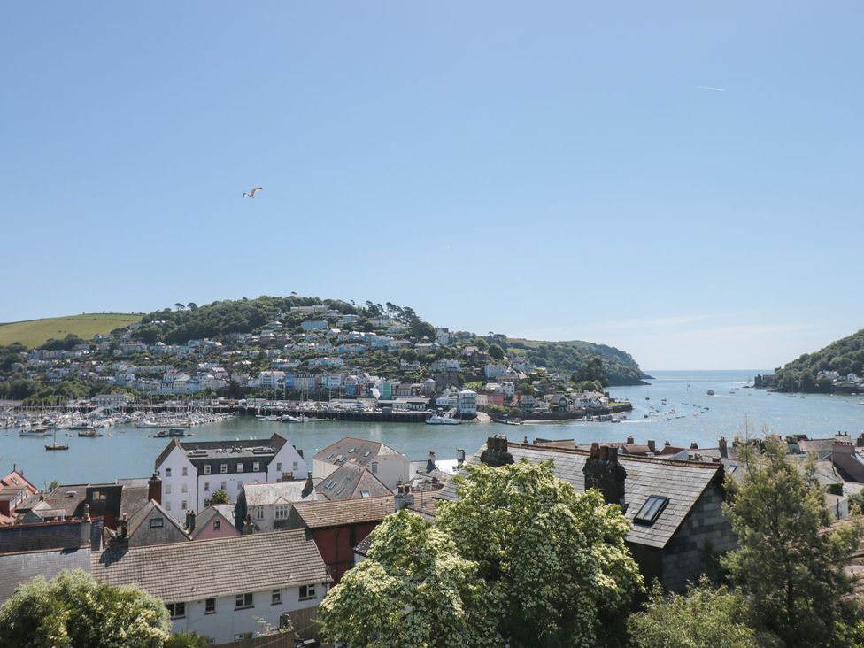 A view of the waterfront with boats and houses at Ty'r Ddraig in Dartmouth
