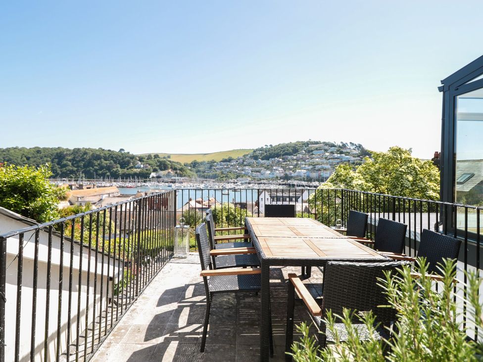 An outdoor dining area with a view at Ty'r Ddraig in Dartmouth
