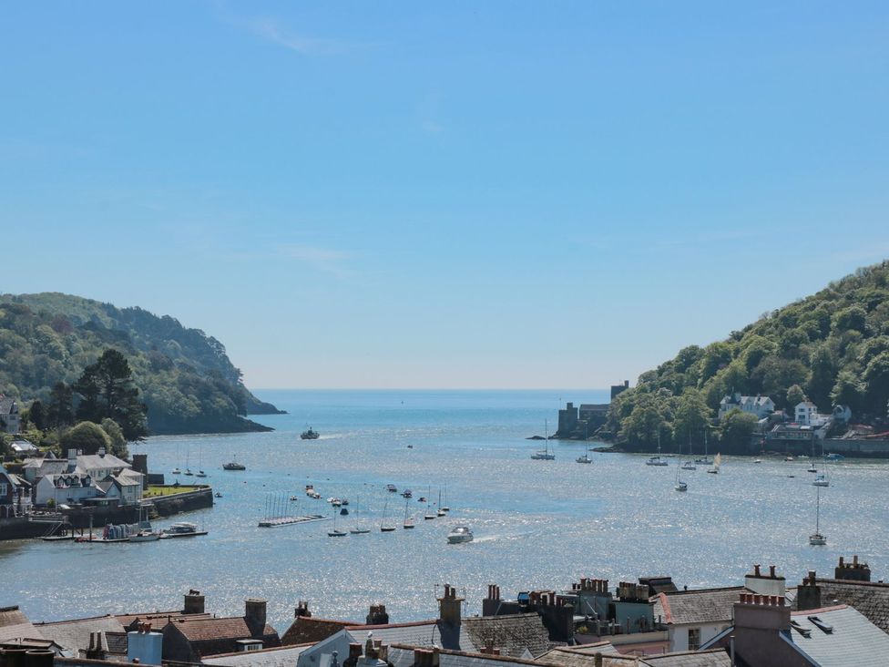 A view of water with boats and hills at Ty'r Ddraig in Dartmouth