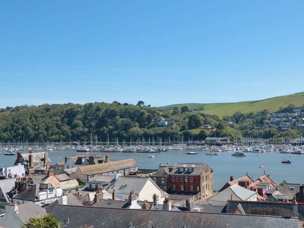 A view of boats on water and houses near the river at Ty'r Ddraig in Dartmouth