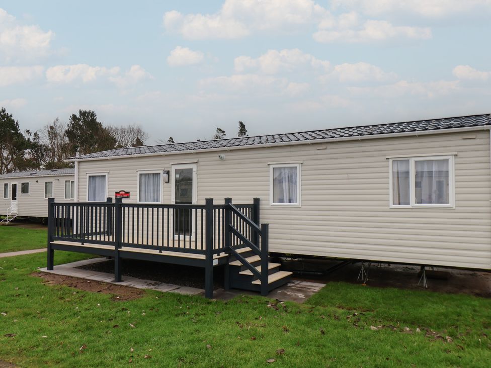 A mobile home with a deck and steps at No. 7 Ivy in Scarborough