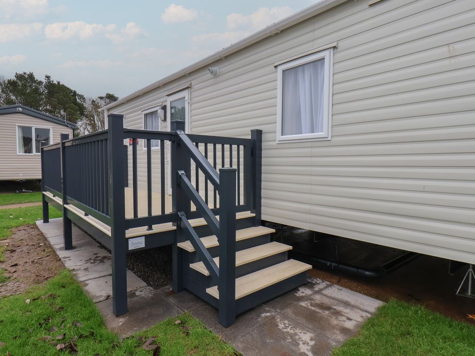A mobile home with a deck and steps at No. 7 Ivy Scarborough