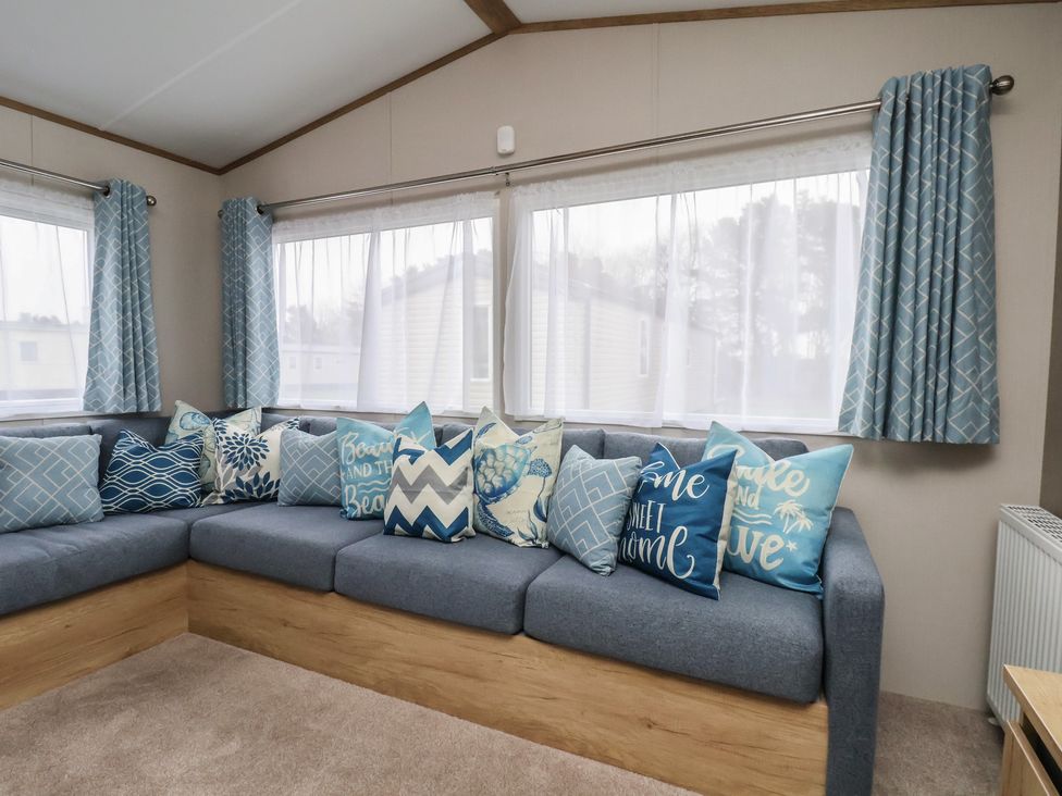 A living room with a sofa and cushions at No. 7 Ivy in Scarborough