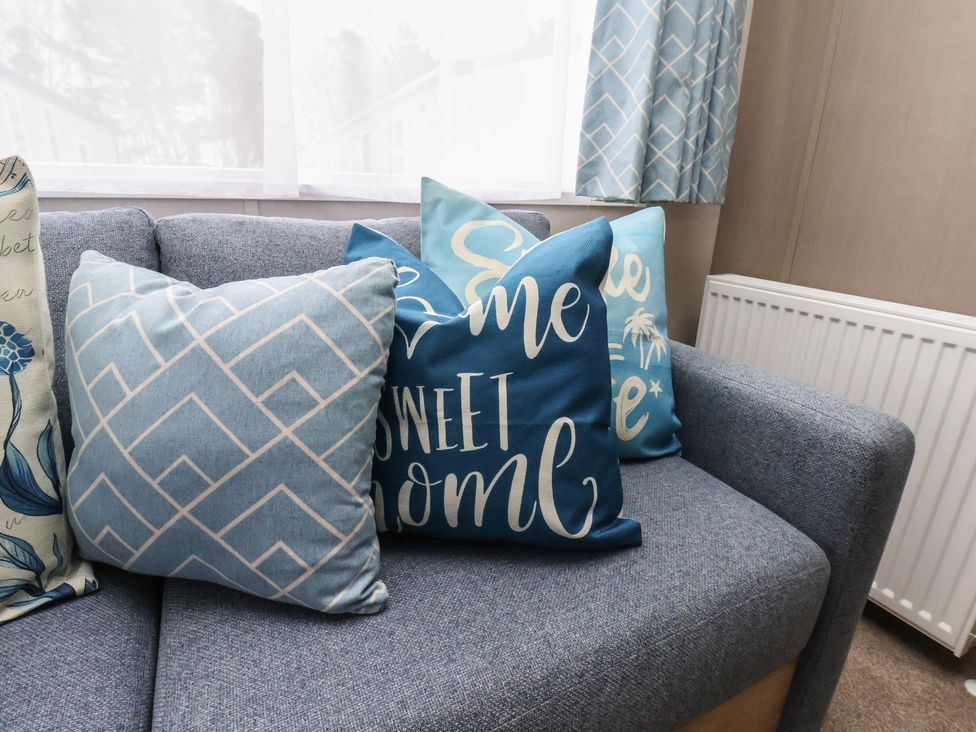 A sofa with decorative cushions at No. 7 Ivy Scarborough