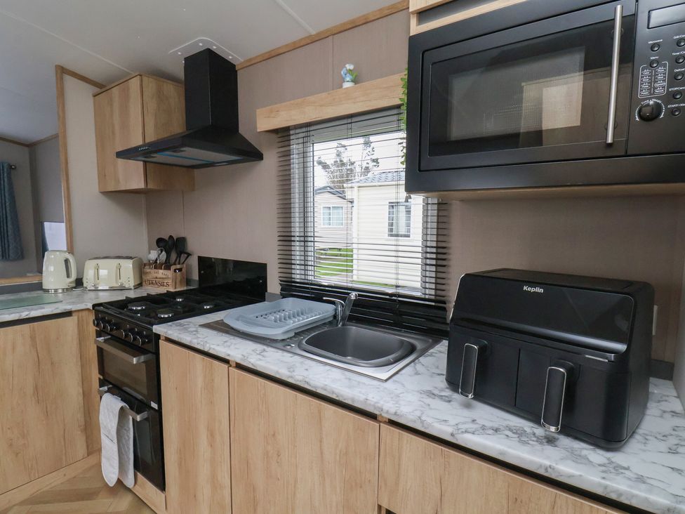 A kitchen with appliances and sink at No. 7 Ivy in Scarborough