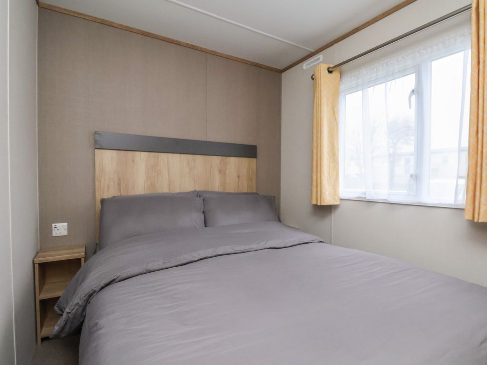 A bedroom with a bed and window at No. 7 Ivy in Scarborough