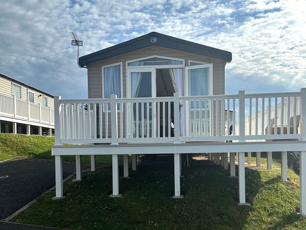 A mobile home with a deck and steps at TW89 in Exmouth