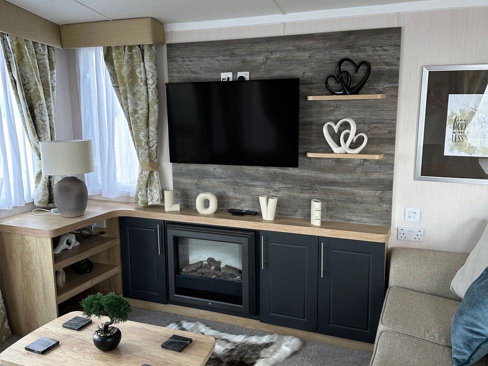 A living room with a television and fireplace at TW89 in Exmouth