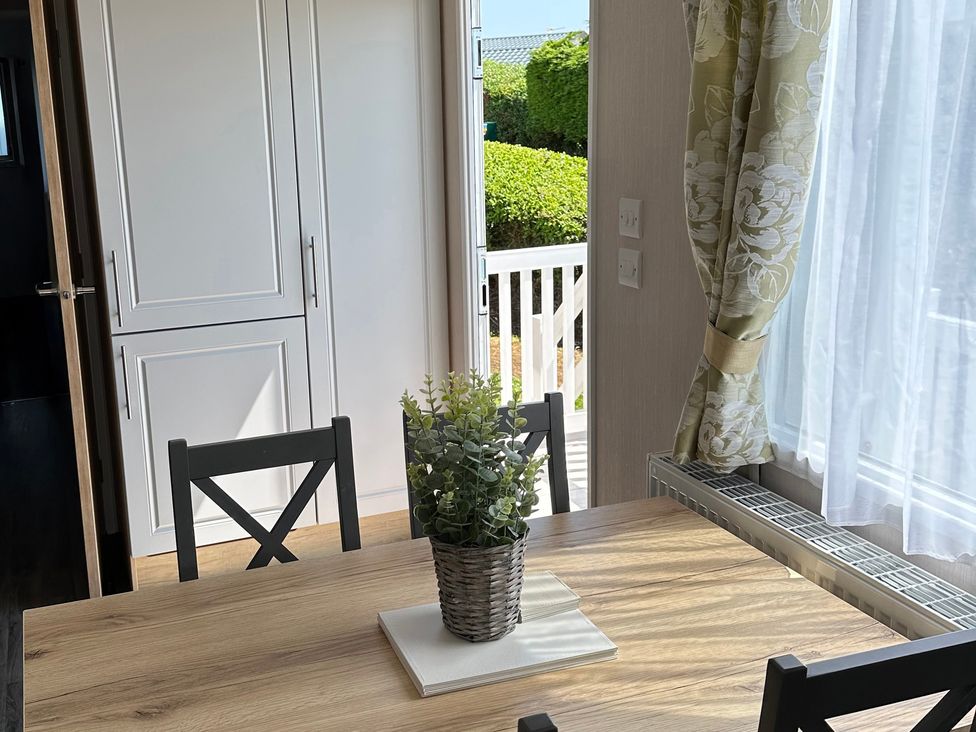 A dining room with table and chairs at TW89 in Exmouth