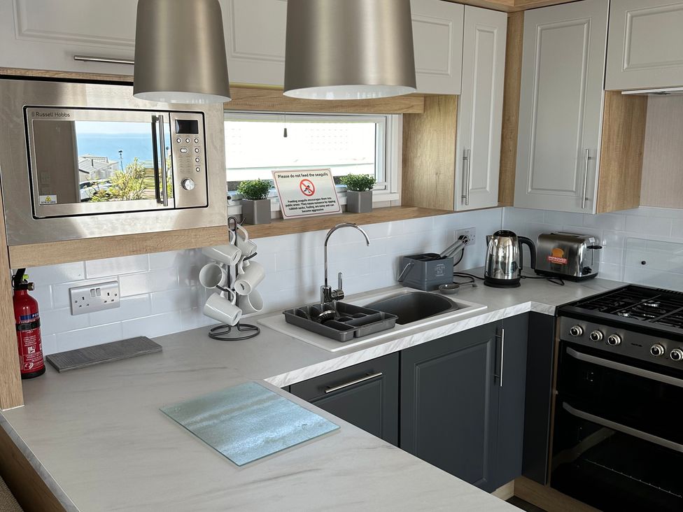 A kitchen with a sink and microwave at TW89 Exmouth