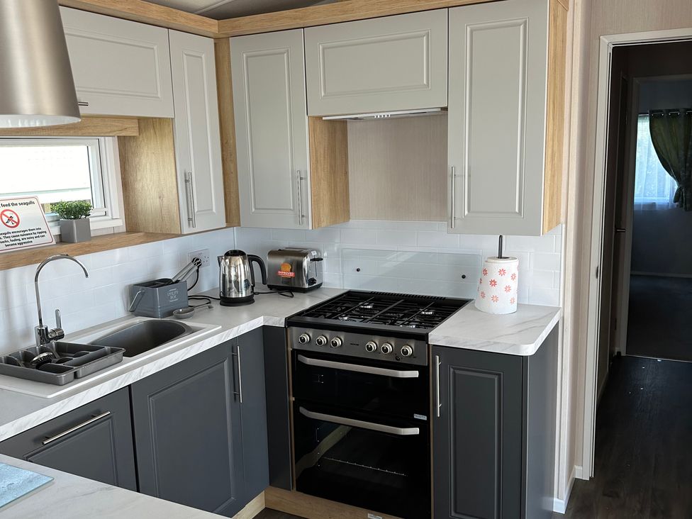 A kitchen with appliances and sink at TW89 in Exmouth