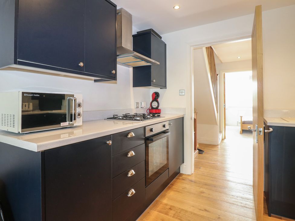 A kitchen with cabinets and appliances at No 1 The Crickets in Bognor Regis