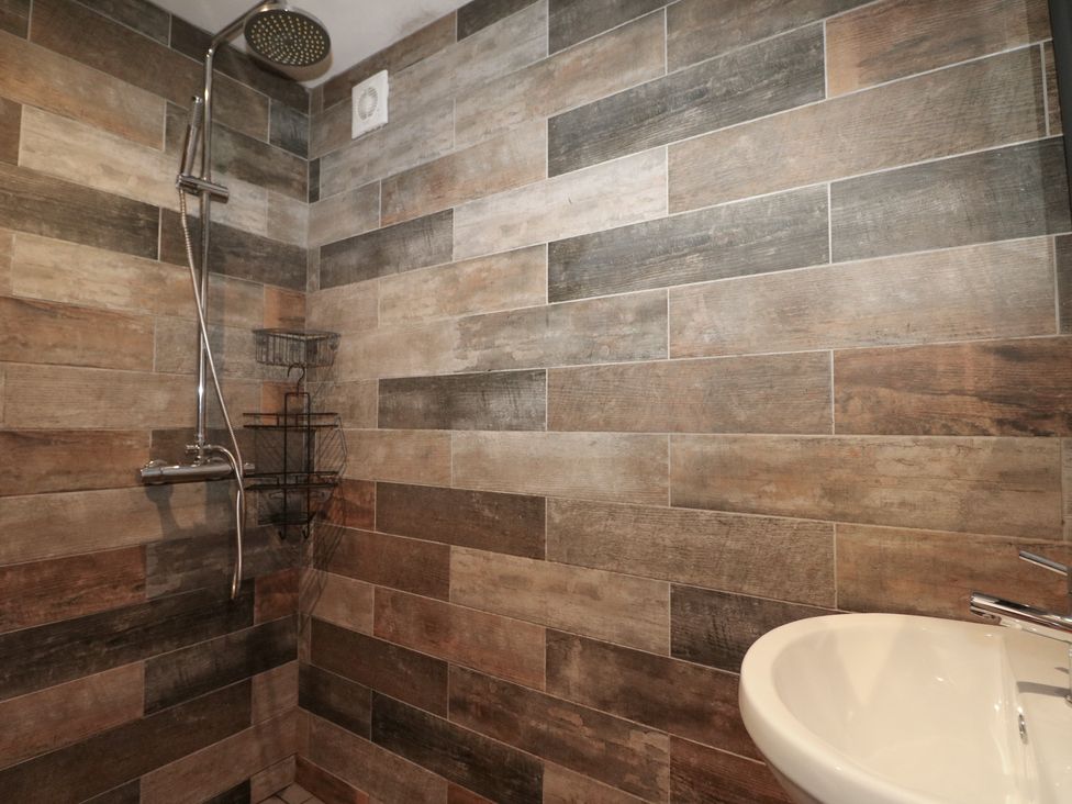 A bathroom with shower and sink at No 1 The Crickets in Bognor Regis