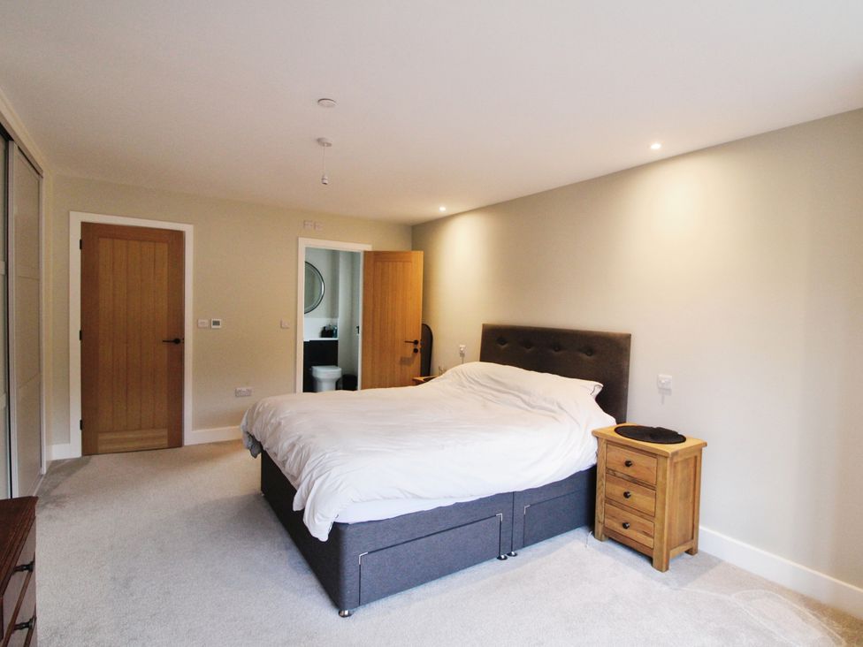 A bedroom featuring a bed and a nightstand at Cefn Coed in Presteigne