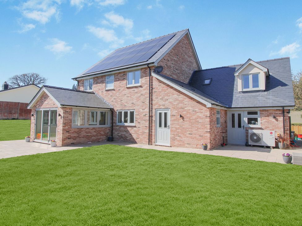 A house with a lawn and patio area at Cefn Coed in Presteigne