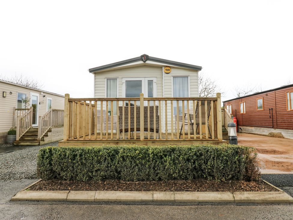 A mobile home with decking and bush at Plot 42 in Carlisle