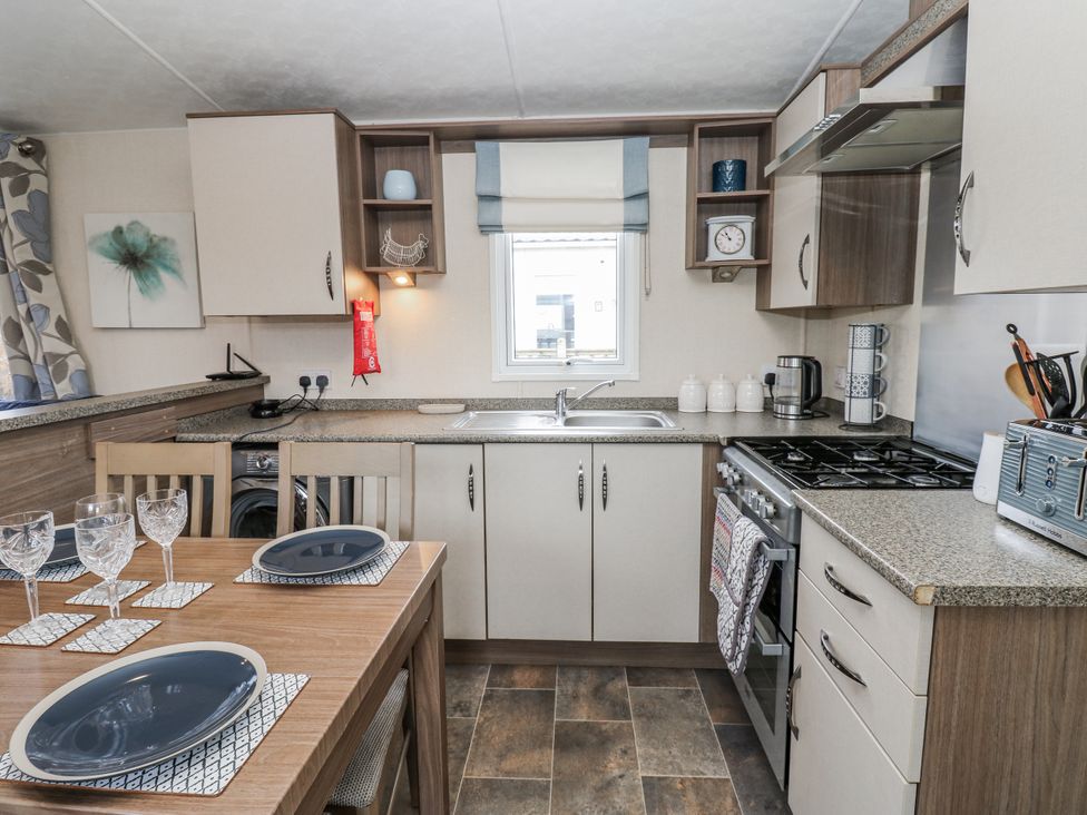 A kitchen with a dining table and chairs at Plot 42 in Carlisle