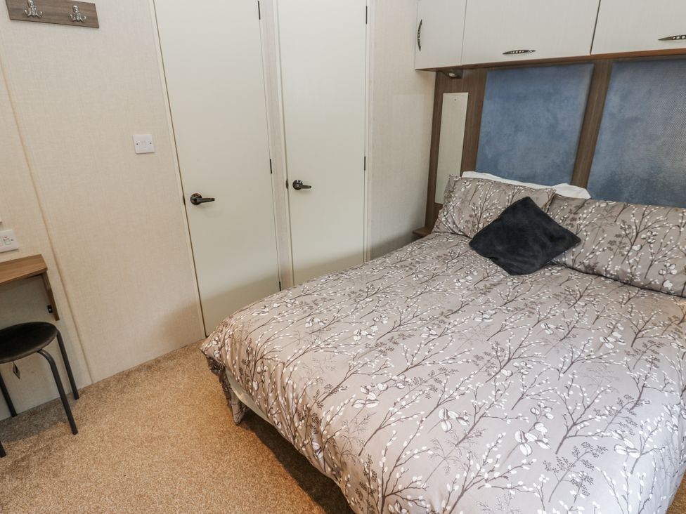 A bedroom with a bed and a chair at Plot 42 in Carlisle