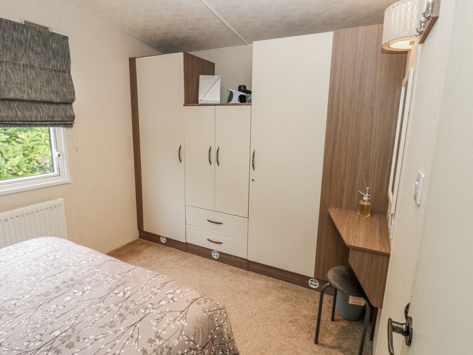 A bedroom with a bed and wardrobe at Plot 42 Carlisle