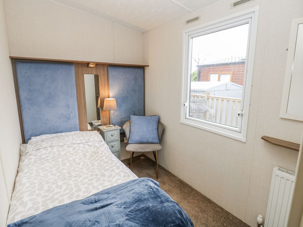 A bedroom with a bed and lamp at Plot 42 in Carlisle