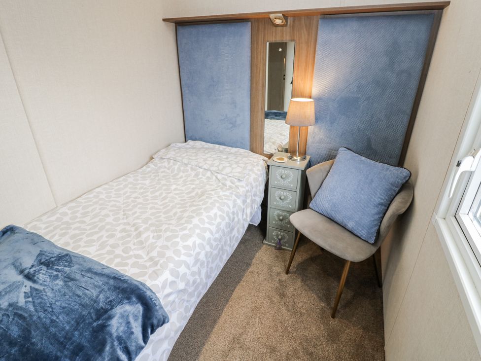 A bedroom with a bed and nightstand at Plot 42 Carlisle