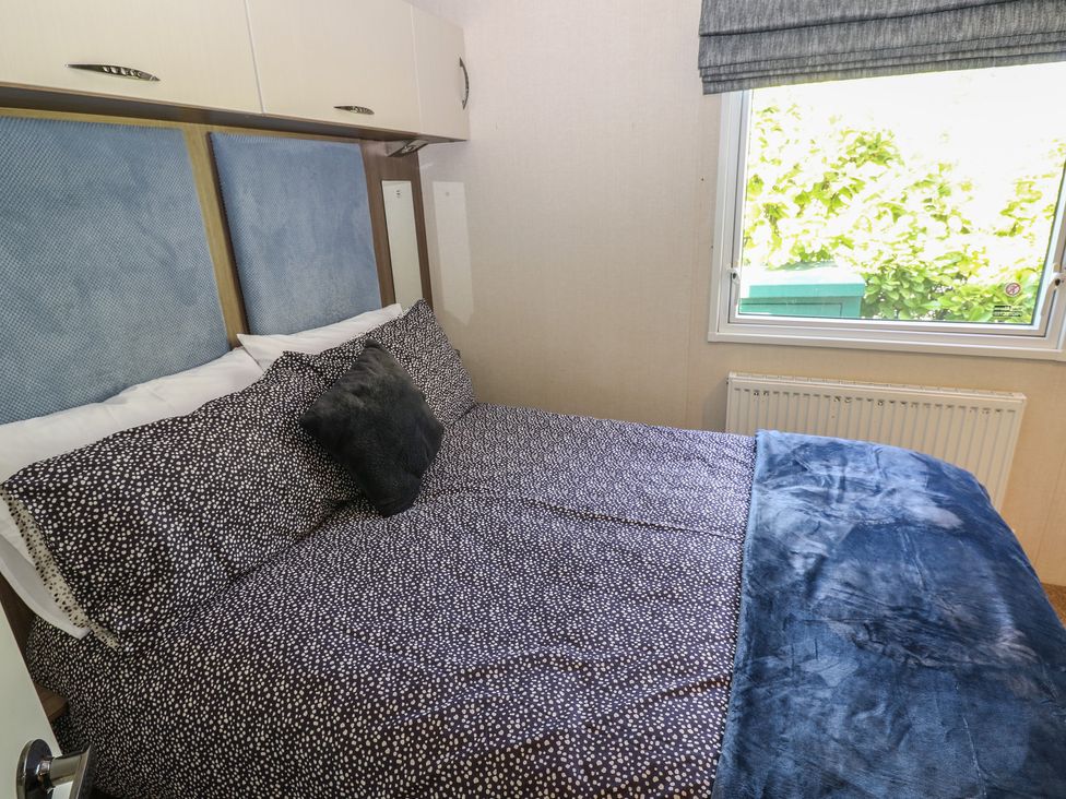 A bedroom with a bed and window at Plot 42 Armathwaite