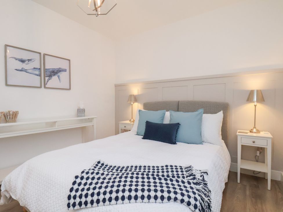 A bedroom with a bed and desk at The Nest in Buckton near Bridlington