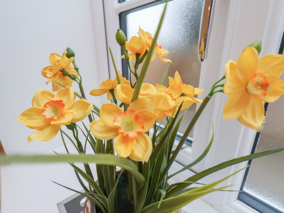 A bouquet of yellow flowers near a window at The Nest Buckton near Bridlington