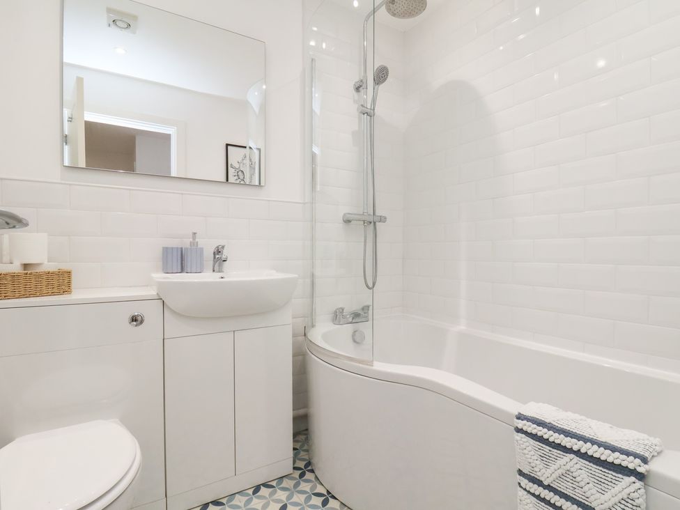 A bathroom with a shower and bath tub at The Nest in Buckton near Bridlington