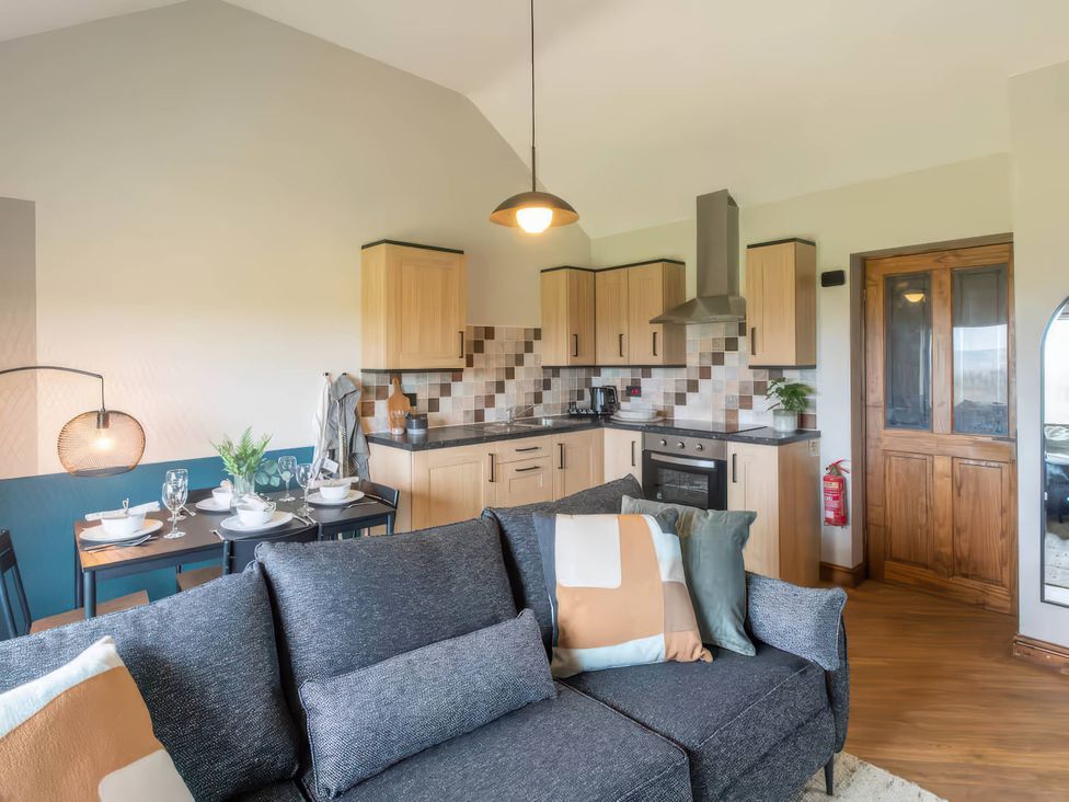 A kitchen with dining area at Black Bird Cottage Llangaffo