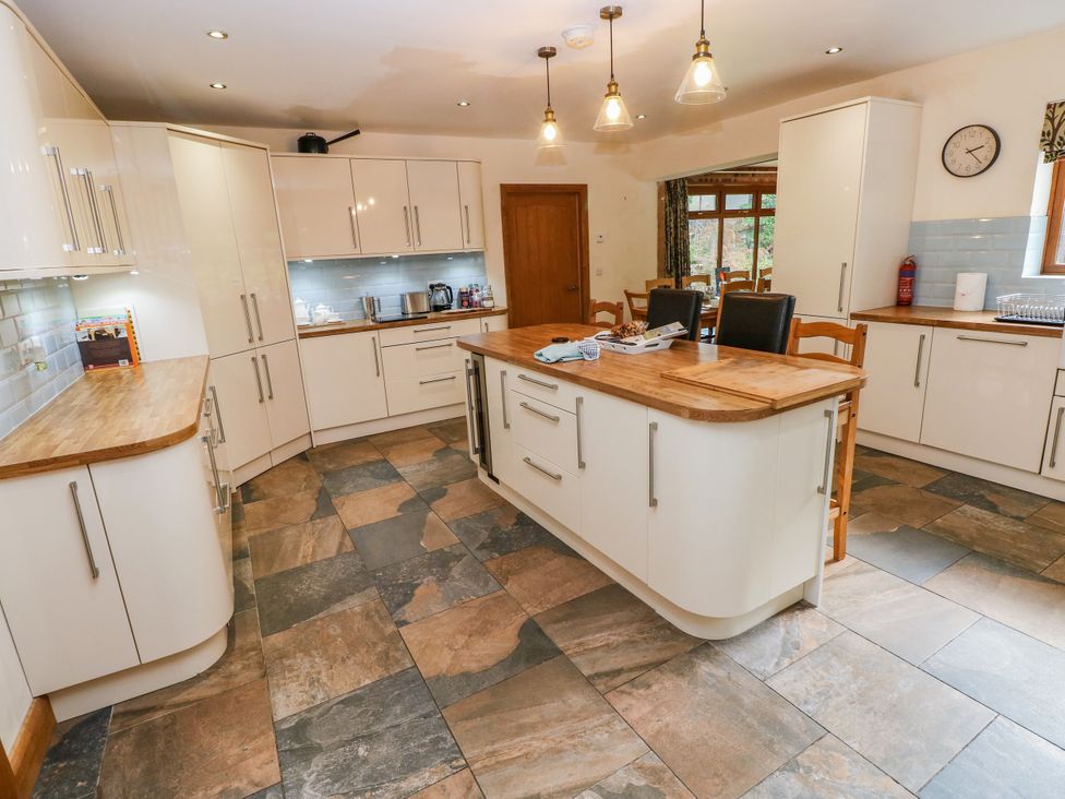 A kitchen with cabinets and an island at Ty-Gan Dderwen in Llangennech, Llanelli
