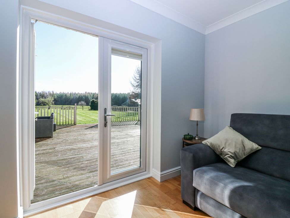 A living room with a sliding door leading to a deck at Norwood