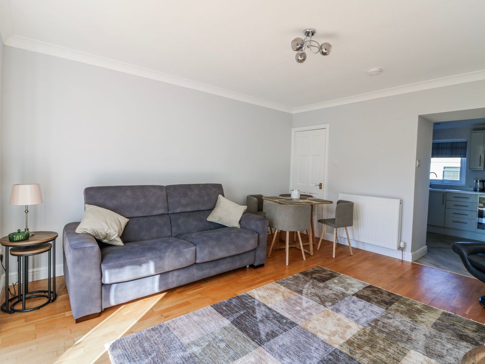 A living room with a sofa, table, and chairs at Norwood