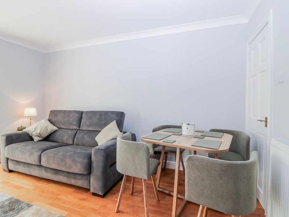 A living room with a sofa and dining table at Norwood