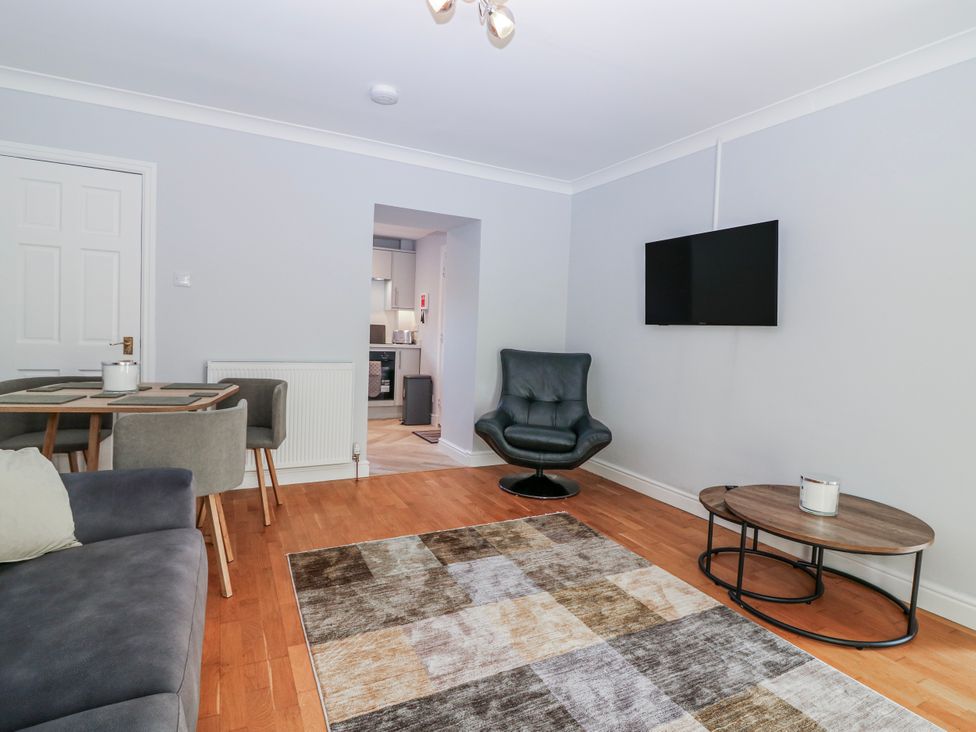 A living room with a sofa and a dining table at Norwood