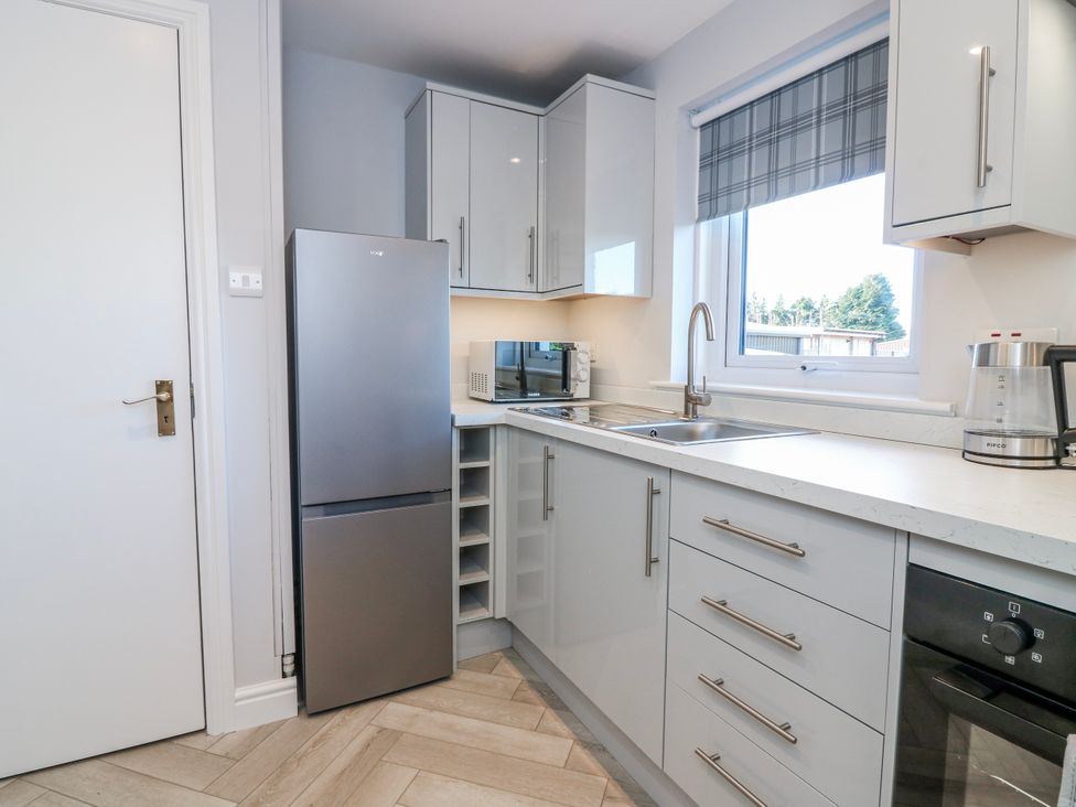 A kitchen with a refrigerator, microwave, and sink at Norwood