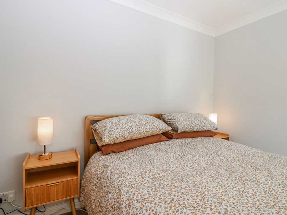 A bedroom with a bed and bedside table at Norwood