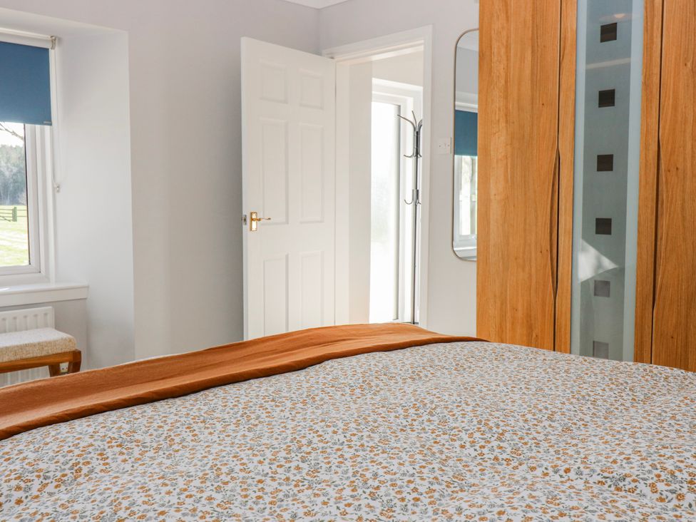 A bedroom with a bed and wardrobe at Norwood