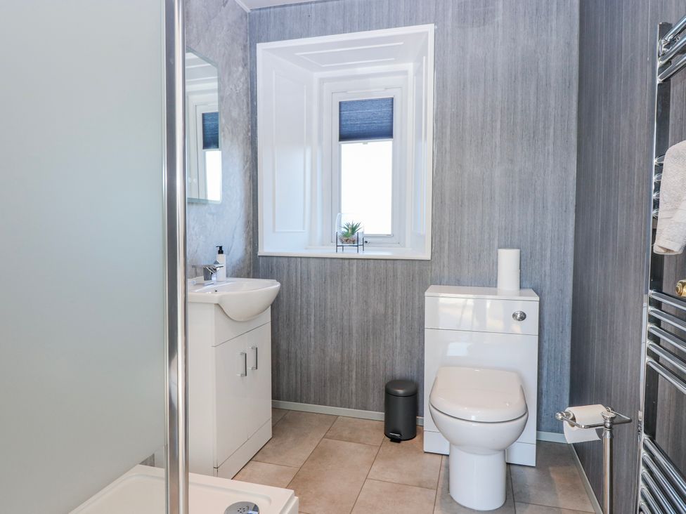 A bathroom with a toilet, sink, and shower at Norwood