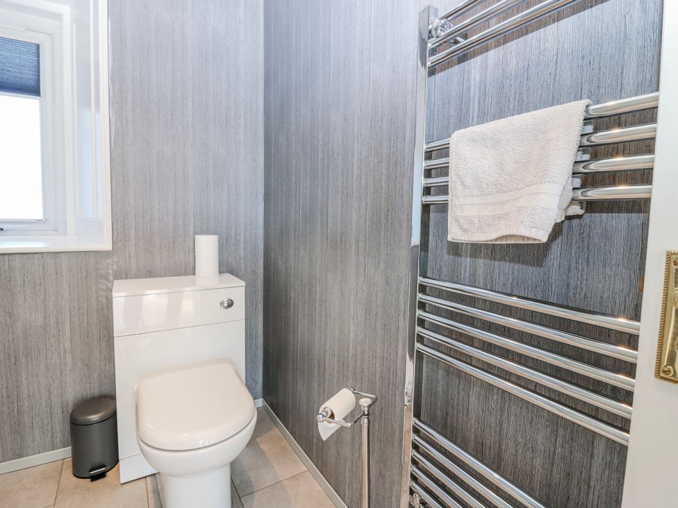 A bathroom featuring a toilet, towel rail, and window at Norwood
