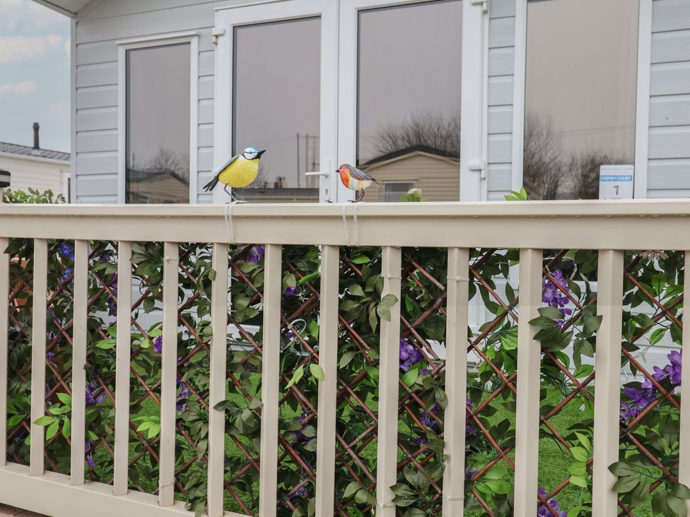 Decorative birds on a railing with foliage at Offspray Court 1 Scratby