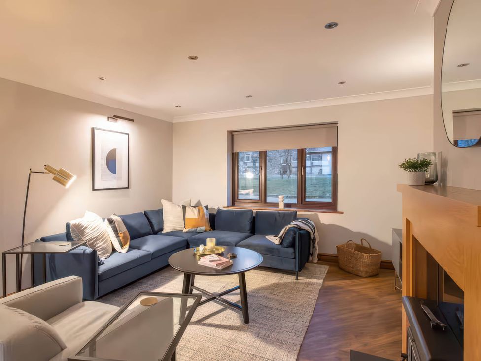 A living room with a sofa and coffee table at Kestrel Cottage Llangaffo