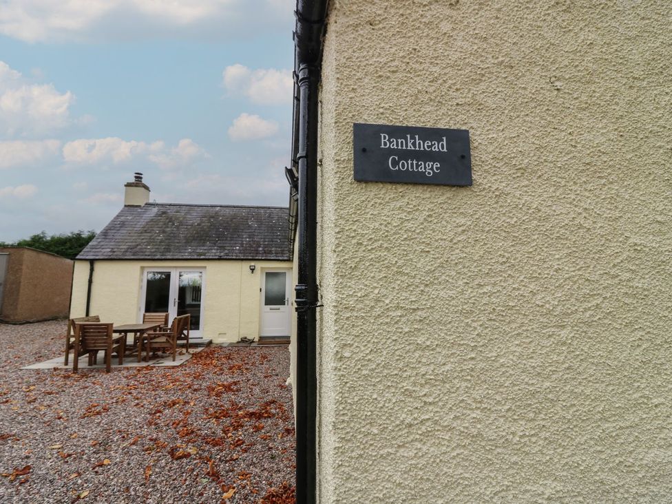 An exterior view of Bankhead Cottage with outdoor seating in Forfar
