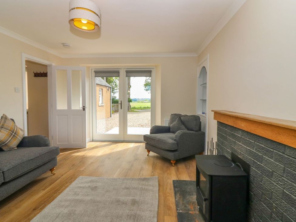 A living room with a sofa and armchair at Bankhead Of Lour Cottage Forfar