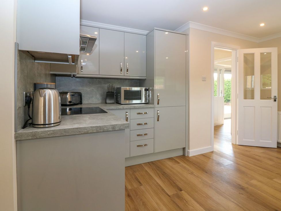 A kitchen with cabinets and appliances at Bankhead Of Lour Cottage Forfar