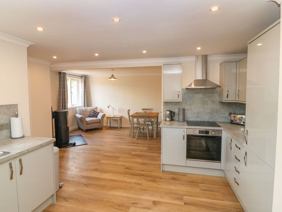A kitchen with sofa and dining area at Bankhead Of Lour Cottage, Forfar