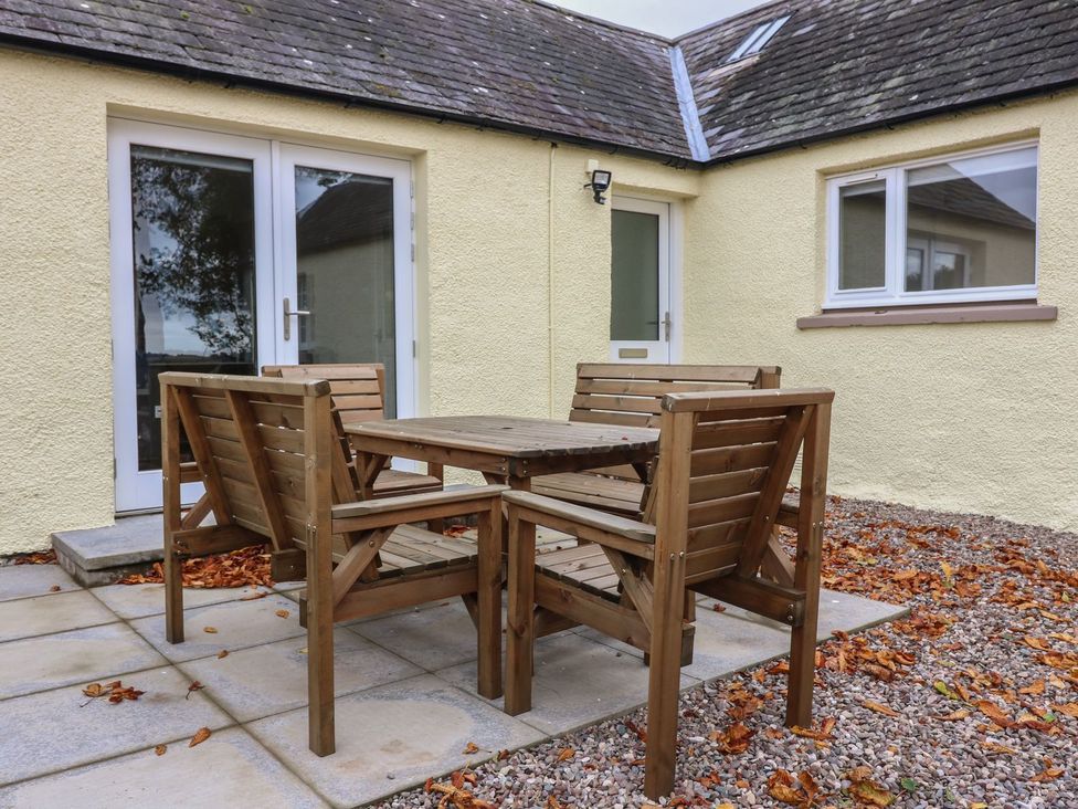 A table and chairs on a patio at Bankhead Of Lour Cottage Forfar